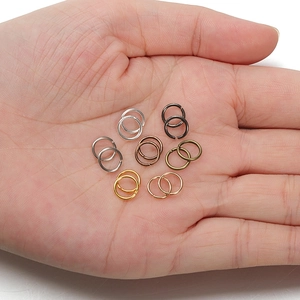 Assorted DIY metal jump rings in multiple metallic finishes held in palm for size scale