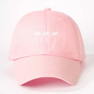 Close-up of three white embroidered coconut trees on a pink cotton baseball cap