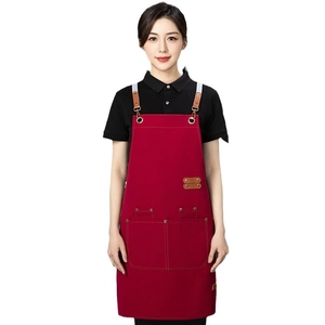 Waterproof red canvas apron with brown leather straps and metal buckles for kitchen work