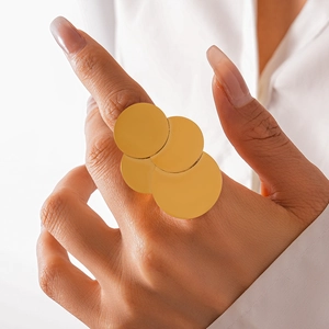 Exaggerated geometric gold ring featuring four layered discs with a brushed metal finish