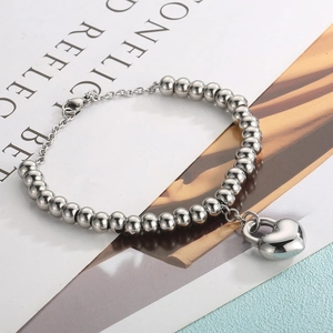 Detailed shot of silver stainless steel ball chain bracelet with polished heart pendant