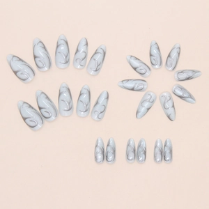 Detail of almond-shaped press on nails with pearl white cat-eye and grey flame pattern