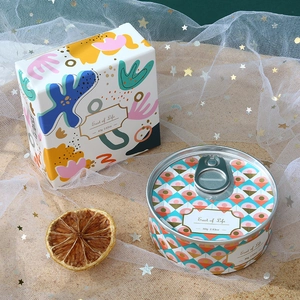 Detailed macro view of 80g tin can scented candle with abstract art packaging box