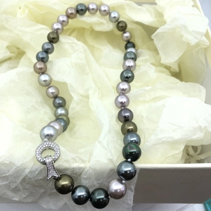 Macro shot of Tahitian pearl necklace in black and grey tones with diamond clasp
