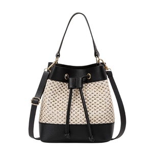 Chic beige straw bucket bag with black leather trim and adjustable crossbody strap