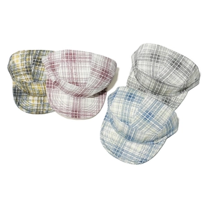 Close-up of four colorful plaid pattern baseball caps in cotton fabric on white background