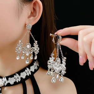 Silver chandelier earrings with crystal tassels and teardrop stones in a clip-on design