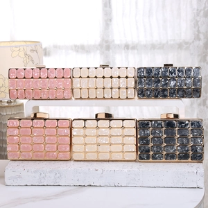 Detail of marble pattern acrylic evening clutch bags with golden metal frames and clasps