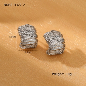 Macro detail of silver pleated hoops showing textured woven design on orange satin