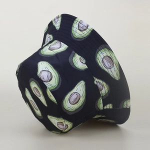 Close-up of reversible bucket hat with detailed green avocado fruit print on black fabric