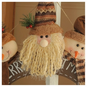 Detail of Santa and Snowman plush ornaments with Merry Christmas wooden sign decoration
