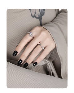 Detail of silver S925 rings featuring purple butterfly and geometric zircon on model hand