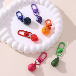 Set of 6 colorful resin fruit keychains featuring cherry, strawberry, and grape designs