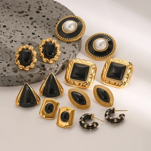 Gold and black stainless steel earring set with enamel and pearl accents on rock base