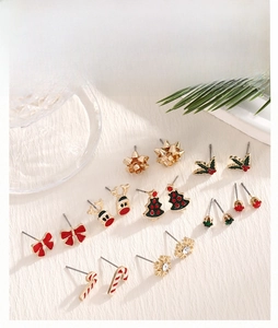 Detail of 9-piece Christmas stud earring set with enamel reindeer and snowflake designs
