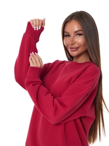 Close-up of red crew neck sweatshirt featuring ribbed cuffs and a dropped shoulder seam