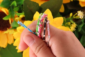 Close-up of colorful enamel stackable rings set with cubic zirconia stones