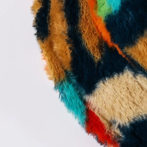 Close-up of vibrant faux fur texture on a colorful striped winter bucket hat