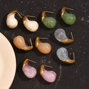 Detail view of colorful teardrop earrings with marble texture and gold plated finish
