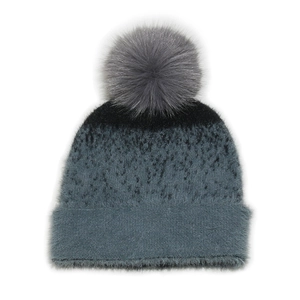 Close-up of grey and black gradient knit beanie with a fluffy faux fur pompom on top