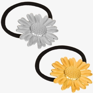 Detailed shot of two black hair ties with silver and gold daisy metal charms