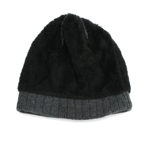 Detail of soft black faux fur winter beanie with grey ribbed knit cuff for warmth