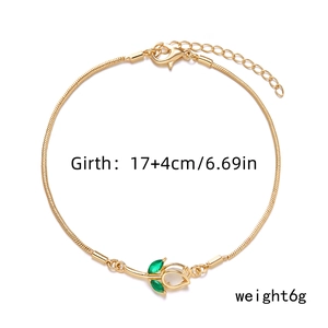 Golden tulip bracelet featuring green leaf charms with detailed sizing and weight info