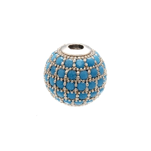 Macro shot of micro-pave round copper bead with blue crystals for DIY jewelry making