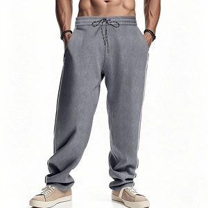 Detail of men's grey corduroy pants featuring elastic drawstring waist and straight fit