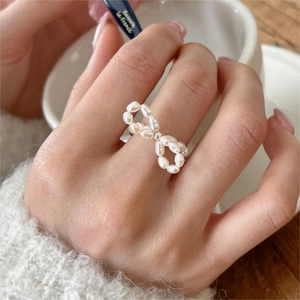 Baroque freshwater pearl bow elastic ring in S925 sterling silver on model's finger