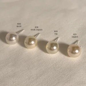 Detail showing four shades of 8mm pearl stud earrings from white to cream rose