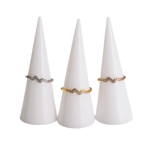 Three wave-shaped stainless steel rings in silver, gold, and rose gold with pavé diamonds