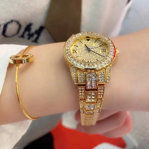 Detailed close-up of a gold quartz watch featuring a crystal-encrusted bezel and dial