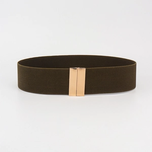 Detail of dark green elastic waist belt featuring a polished gold metallic buckle closure