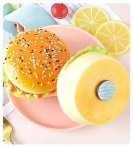 Detailed view of artificial burger fridge magnets showing sesame seeds and magnetic base