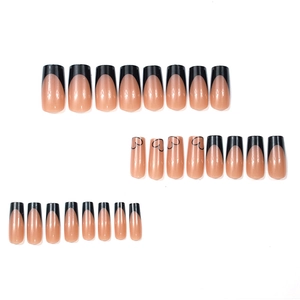 French tip press-on nails in nude pink with black hearts and square shape long nails