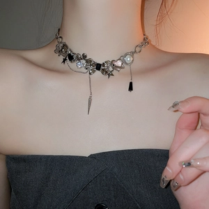 Detail of Y2K necklace with heart and star pendants on a model's neck for a punk look