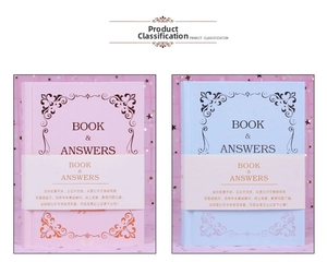 Detailed view of pink and blue Book & Answers hardbound notebooks with gold foil stamping