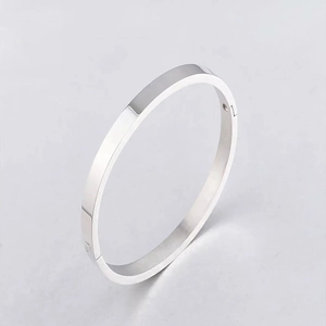 Detailed macro view of polished silver titanium steel bangle with side hinge closure