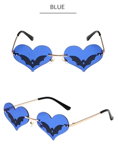 Detail of blue heart sunglasses with bat motifs and gold metal temples on white background