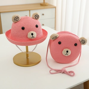 Détail de chapeau de paille rose et sac ourson avec texture tressée pour enfants