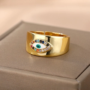 Macro shot of evil eye ring with colorful zircon pavé stones on a jewelry box edge