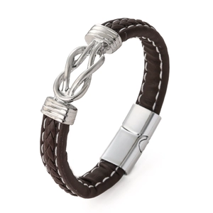 Detail of brown braided leather bracelet with silver knot design and magnetic clasp