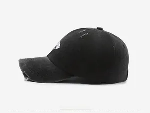 Detailed side view of vintage distressed baseball cap with embroidery and frayed holes