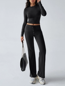 Detail view of black Y2K slim-fit two-piece set with drawstring high-waisted joggers