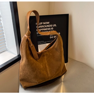 Detail of the brown suede texture and wide shoulder strap on this stylish large hobo bag