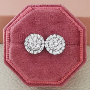 Macro shot of silver round cluster stud earrings with zircons in a pink velvet box