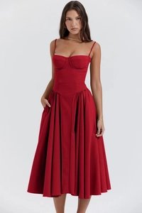 Detail of red French retro strap dress featuring corset bodice and flowy pleated skirt