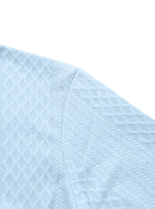 Macro shot of light blue jacquard shirt fabric with refined diamond weave texture