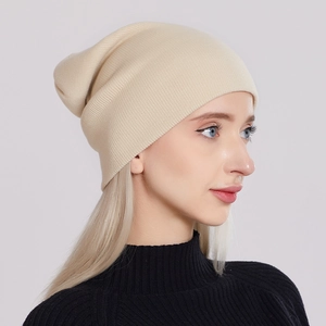 Stylish cream knitted beanie hat for unisex outdoor winter wear on model profile